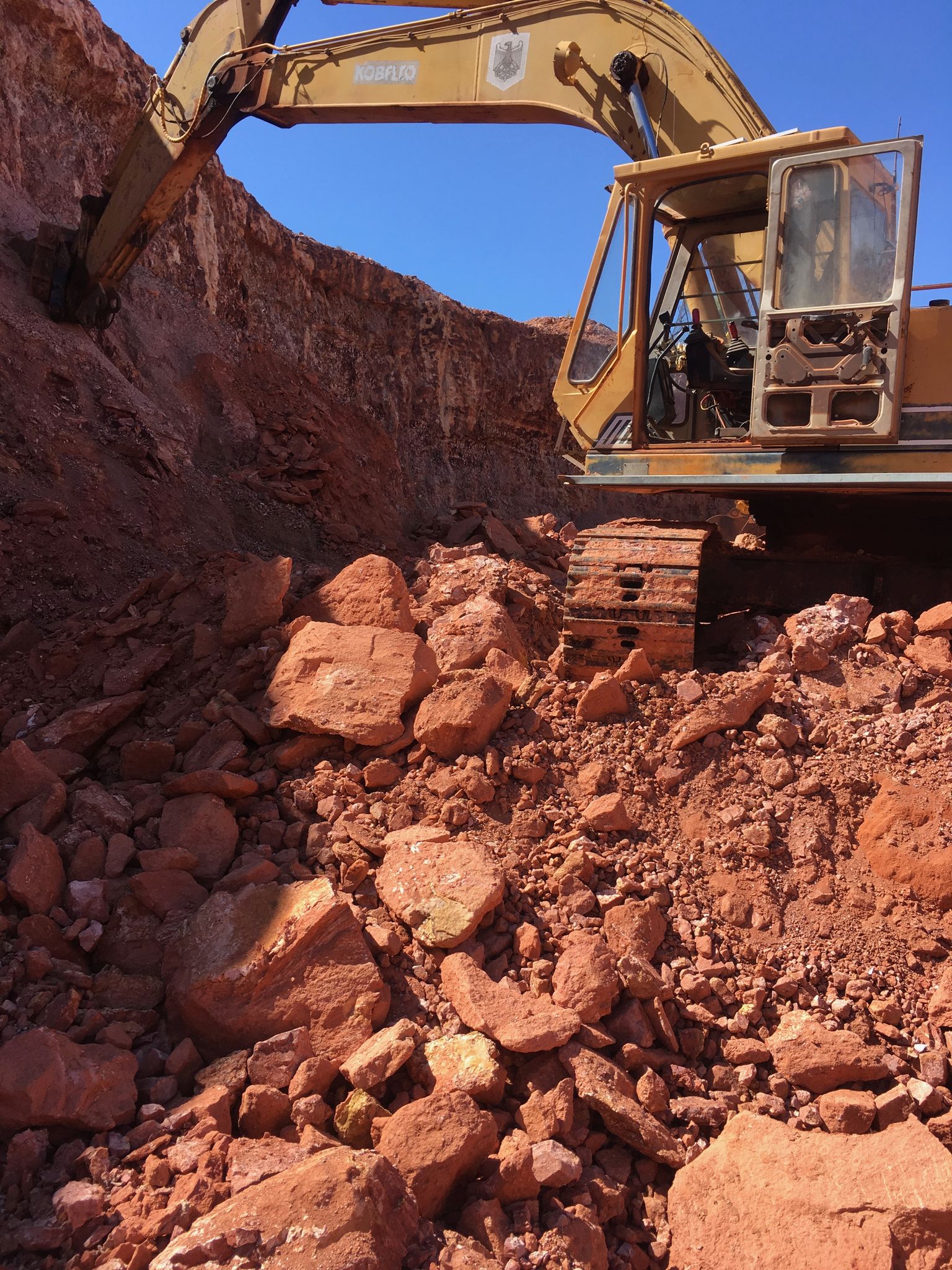 Understanding Boulder Opal - - digger scraping the rock credit barbara kolator