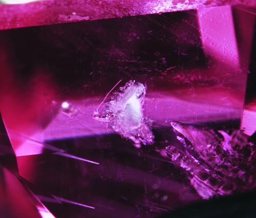 A translucent, whitish inclusion of talc commonly observed in rubies and pink sapphires from Greenland. Magnification x58. Image courtesy of C. P. Smith. Aappaluttoq Greenland.
